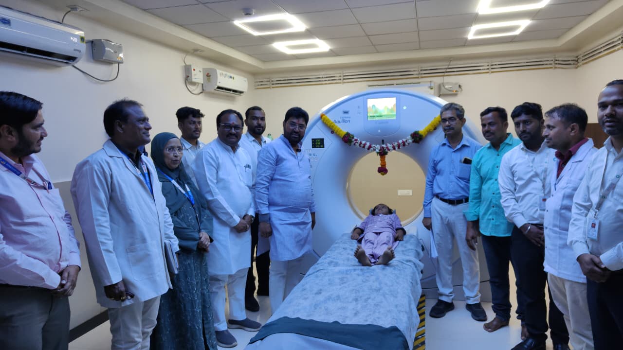 Medical team inaugurating new CT scanner - NewsNation Online A child lying on a medical imaging table inside a CT scanner surrounded by medical staff and technicians in a hospital room