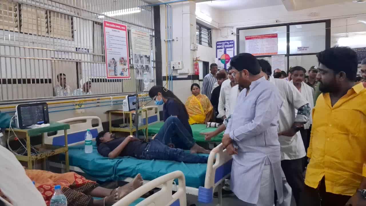 Busy hospital ward with patient care - NewsNation Online Hospital ward with a patient lying on a bed receiving medical care and several visitors and staff standing nearby