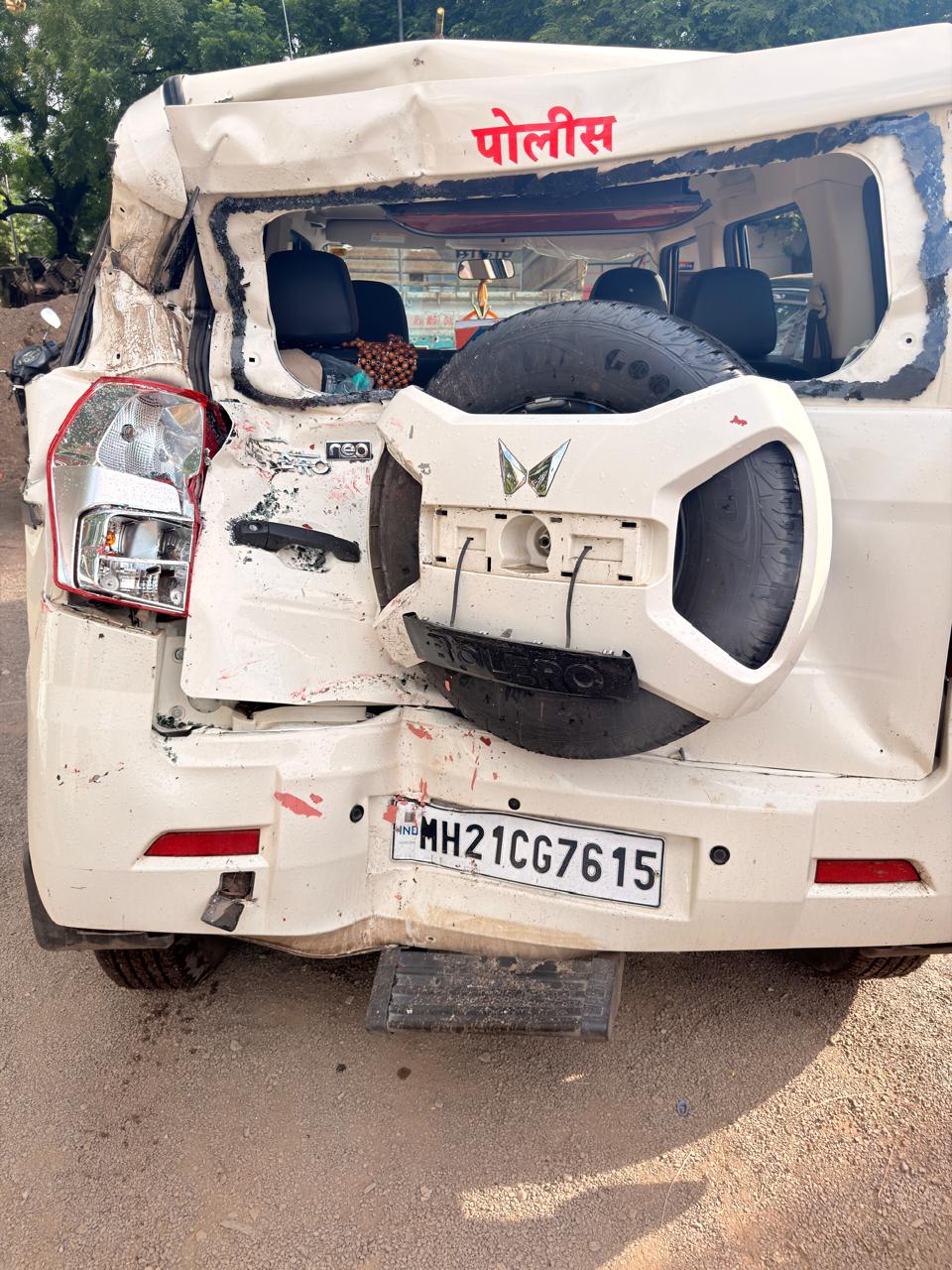 IMG-20260909-WA0016 - NewsNation Online White police van with a rear-mounted spare tire and extensive rear damage from an accident; license plate MH21CG7615, India.