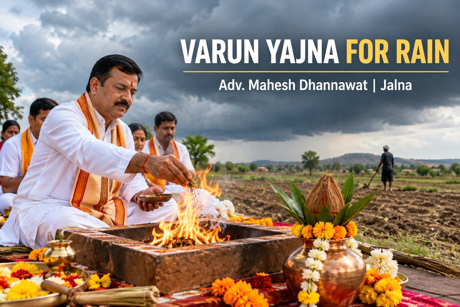 Man in white traditional attire performs Varun Yajna rain ritual beside a sacred fire in an open field, with garlands and vessels nearby.