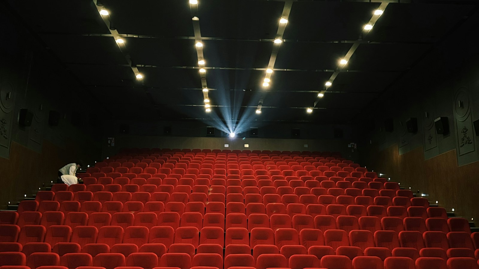 Cinema seats and projector light; illustrative photograph, not a Carrie production still