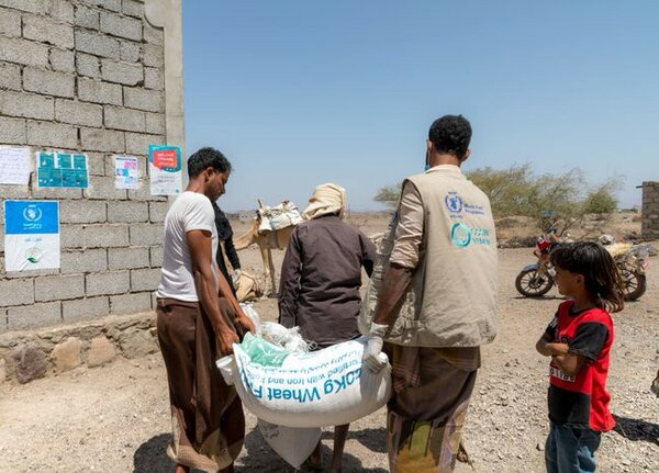 WFP Food Distribution in Yemen - NewsNation Online World Food Programme workers distributing wheat flour in Yemen, illustrating the country's worsening hunger crisis